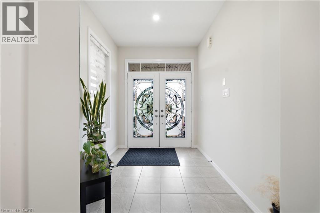 Double entry doors with decorative glass panels, transom window, recessed lighting, and tile flooring - 57 Cheevers Road, Brantford, ON - Indoor Photo Showing Other Room