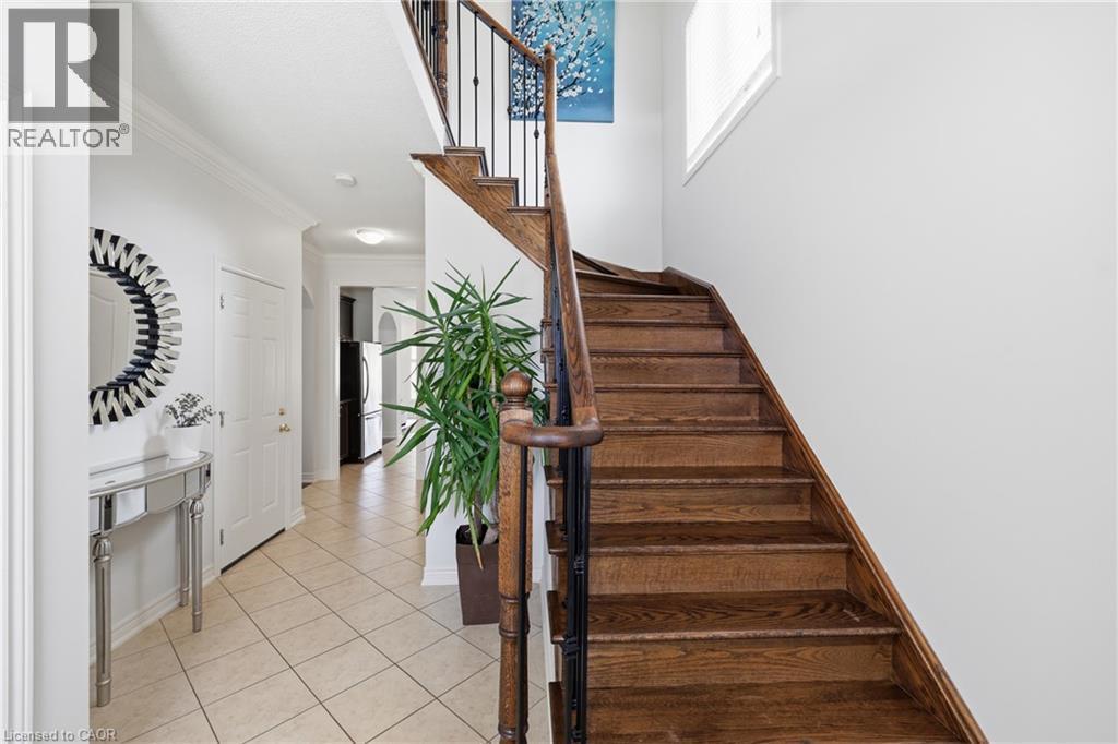 Wood staircase with dark metal spindles and wood handrail - 738 Fourth Line, Milton, ON - Indoor Photo Showing Other Room