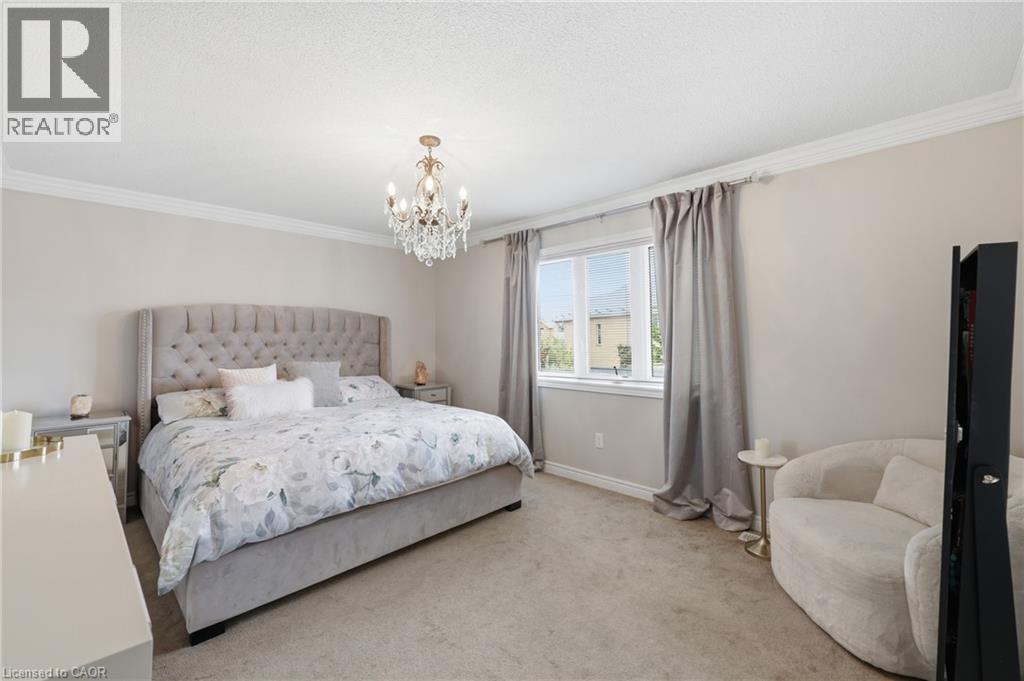 Neutral wall color, crown molding, double window with curtains, chandelier, and carpeted flooring - 738 Fourth Line, Milton, ON - Indoor Photo Showing Bedroom