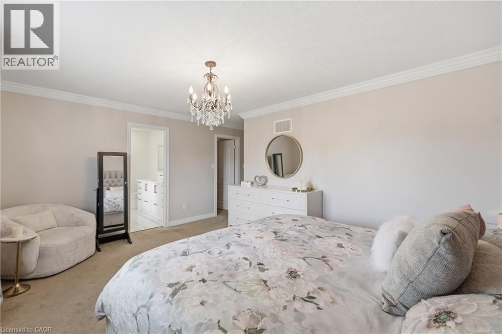 Crowning chandelier, light-toned walls, and soft carpet flooring - 738 Fourth Line, Milton, ON - Indoor Photo Showing Bedroom