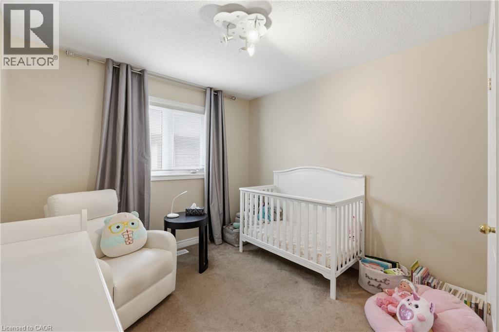 Neutral wall tones, carpeted flooring, a ceiling-mounted light fixture, and a window with blinds - 738 Fourth Line, Milton, ON - Indoor Photo Showing Bedroom