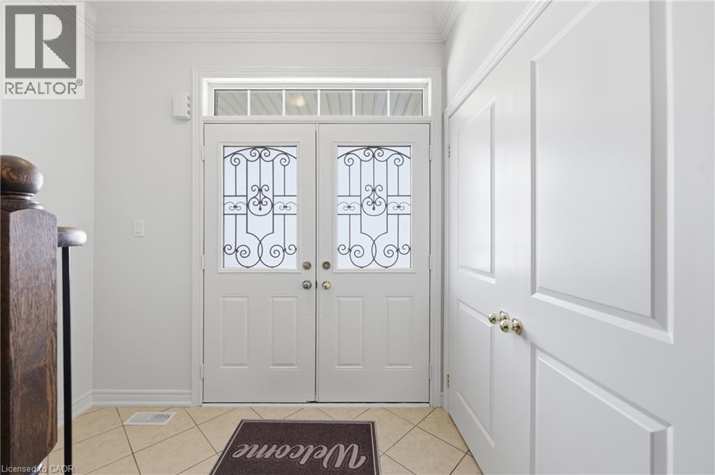 Double entry doors with decorative glass inserts and transom window - 738 Fourth Line, Milton, ON - Indoor Photo Showing Other Room