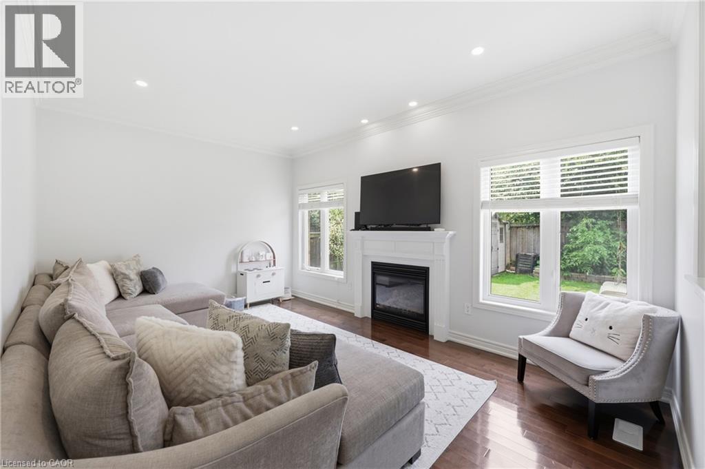 Hardwood flooring, recessed lighting, and crown molding - 738 Fourth Line, Milton, ON - Indoor Photo Showing Living Room With Fireplace
