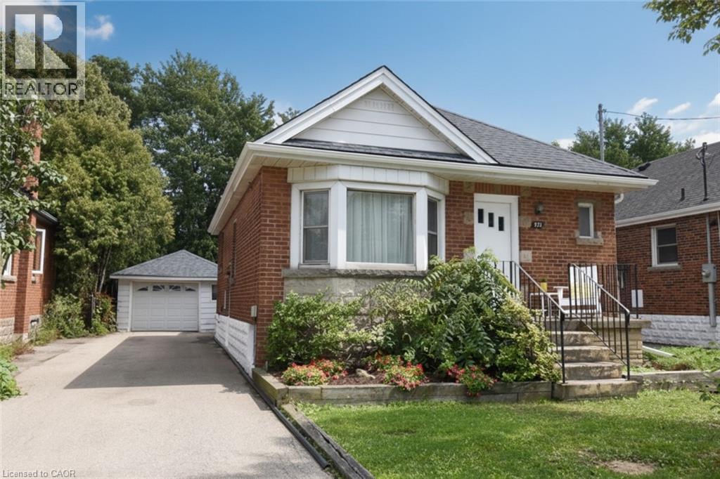 Brick exterior featuring a bay window, concrete front porch, and a dedicated driveway - 575 Upper Wentworth Street, Hamilton, ON - Outdoor