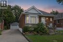Brick exterior with a peaked roofline, front bay window, dedicated driveway, and a detached garage - 575 Upper Wentworth Street, Hamilton, ON  - Outdoor 