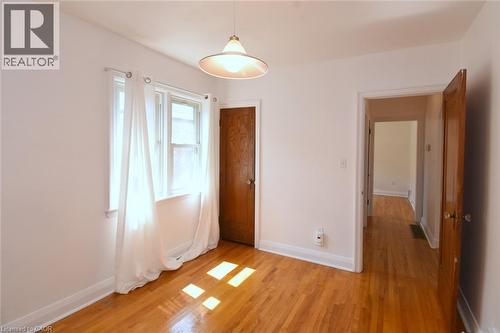 Hardwood flooring, painted walls, white trim, and a ceiling-mounted light fixture - 575 Upper Wentworth Street, Hamilton, ON - Indoor Photo Showing Other Room