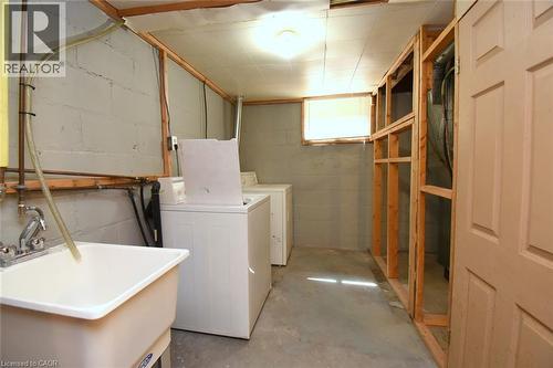 Utility area with a laundry sink featuring a chrome faucet, washer, and dryer - 575 Upper Wentworth Street, Hamilton, ON - Indoor Photo Showing Laundry Room