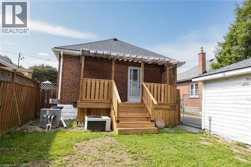 Red brick exterior with a dark shingle roof and white eaves - 575 Upper Wentworth Street, Hamilton, ON - Outdoor With Deck Patio Veranda With Exterior