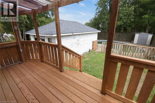 Expansive wood deck with wood railings, overlooking a backyard with a swimming pool and a storage shed - 575 Upper Wentworth Street, Hamilton, ON - Outdoor With Deck Patio Veranda With Exterior