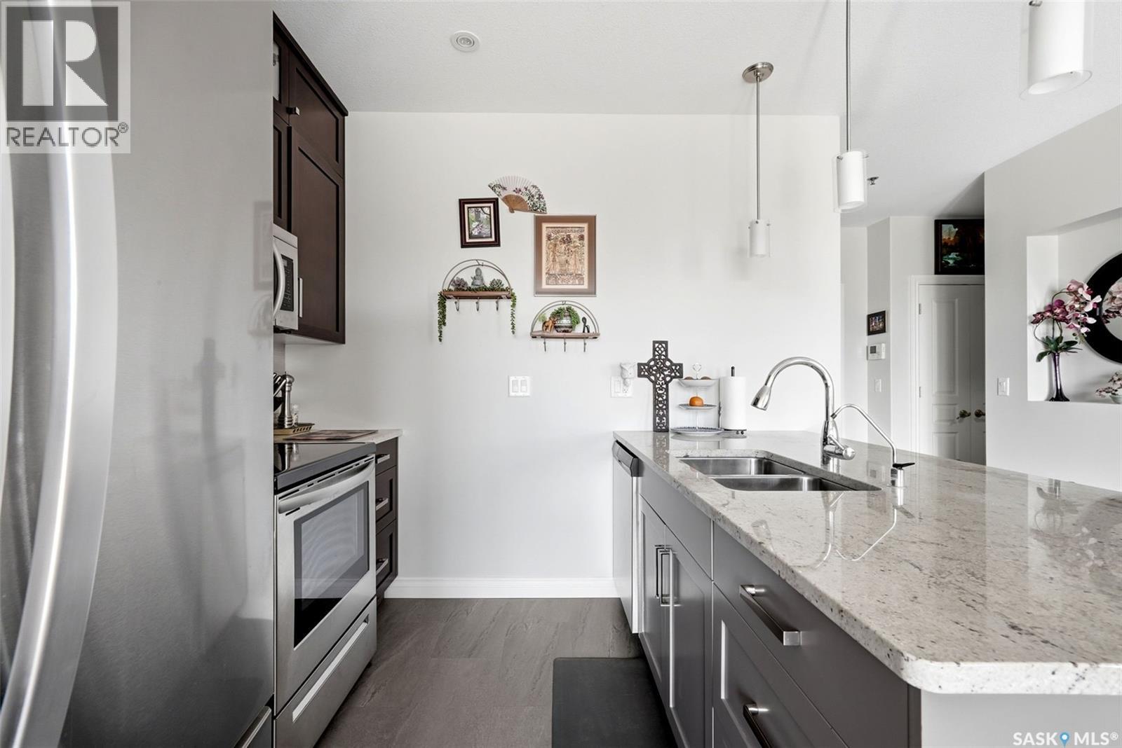 206 1715 Badham Boulevard, Regina, SK - Indoor Photo Showing Kitchen With Stainless Steel Kitchen With Double Sink With Upgraded Kitchen
