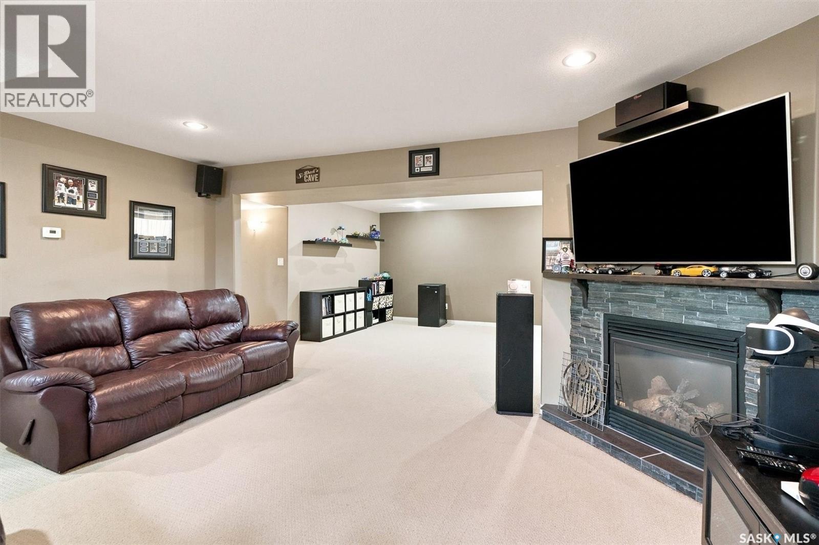 211 Crenshaw Way, Warman, SK - Indoor Photo Showing Living Room With Fireplace