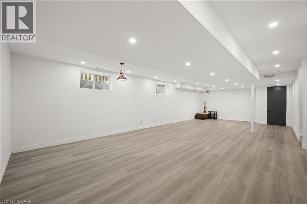 Lower level with kitchen electrical and plumbing roughed in...just ready for cabinetry and appliances! - 163 Redtail Street, Kitchener, ON - Indoor Photo Showing Other Room