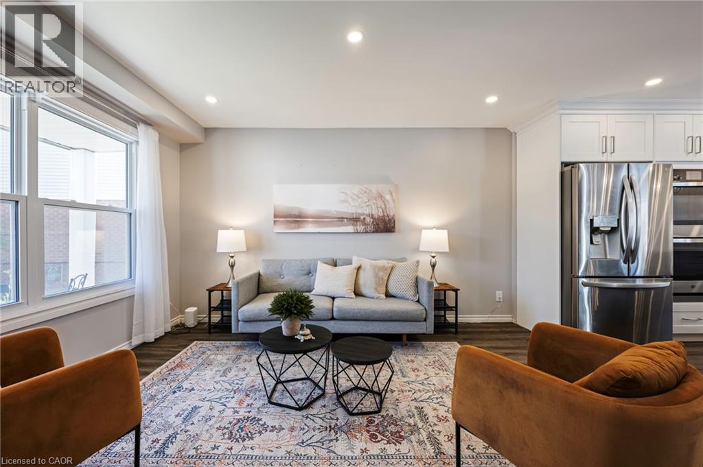 Recessed lighting, wood-finish flooring, white double-hung windows, stainless steel appliances, and white cabinetry - 364 Stoneheight Place, Waterloo, ON