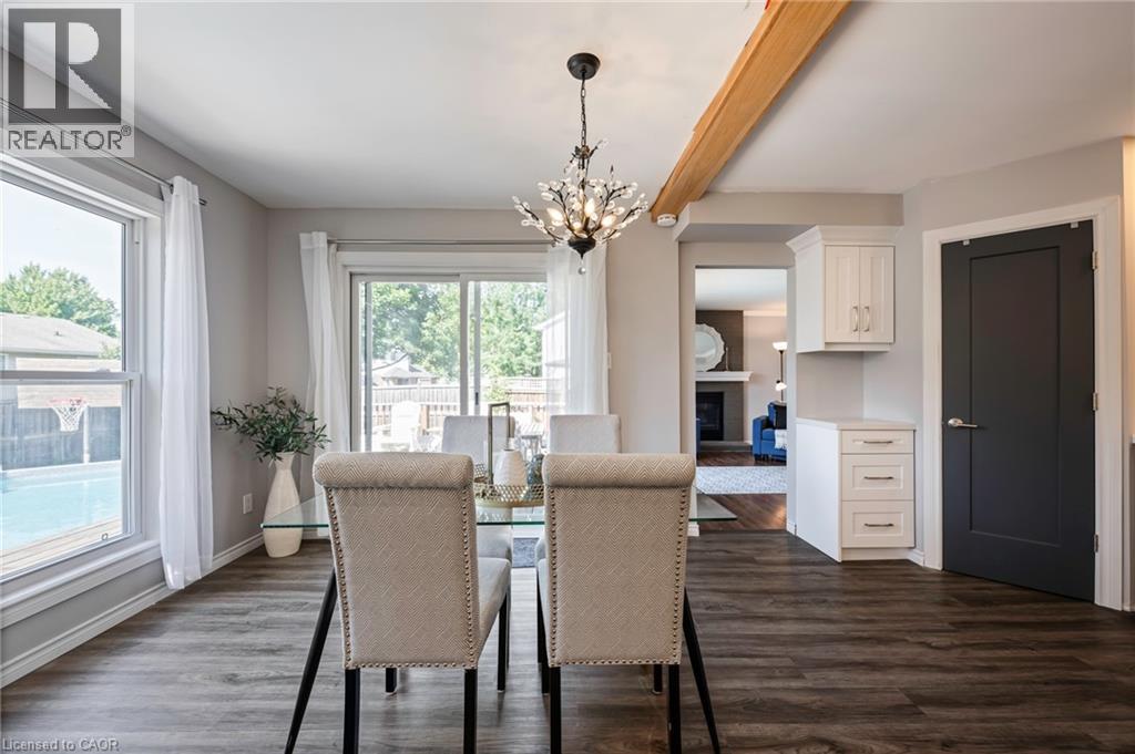 Wood-finish flooring throughout, with a decorative chandelier, and a wood beam accent - 364 Stoneheight Place, Waterloo, ON