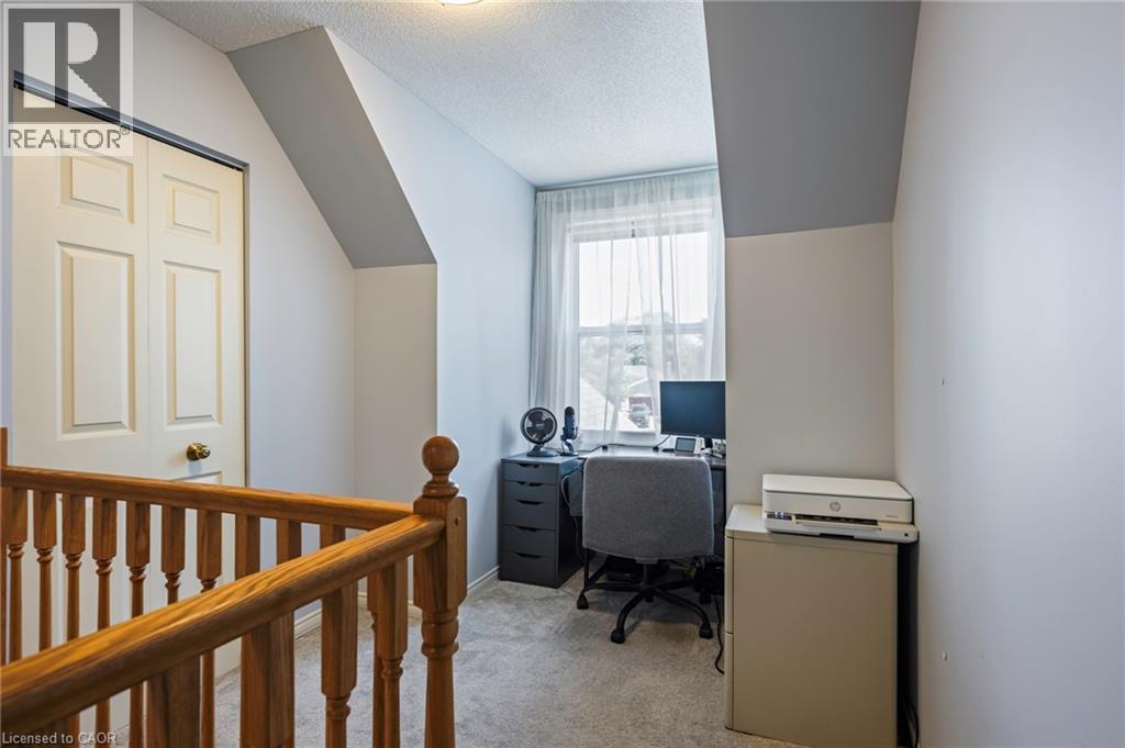 Window with natural light, sloped ceilings, bi-fold closet door, and carpeted flooring - 364 Stoneheight Place, Waterloo, ON
