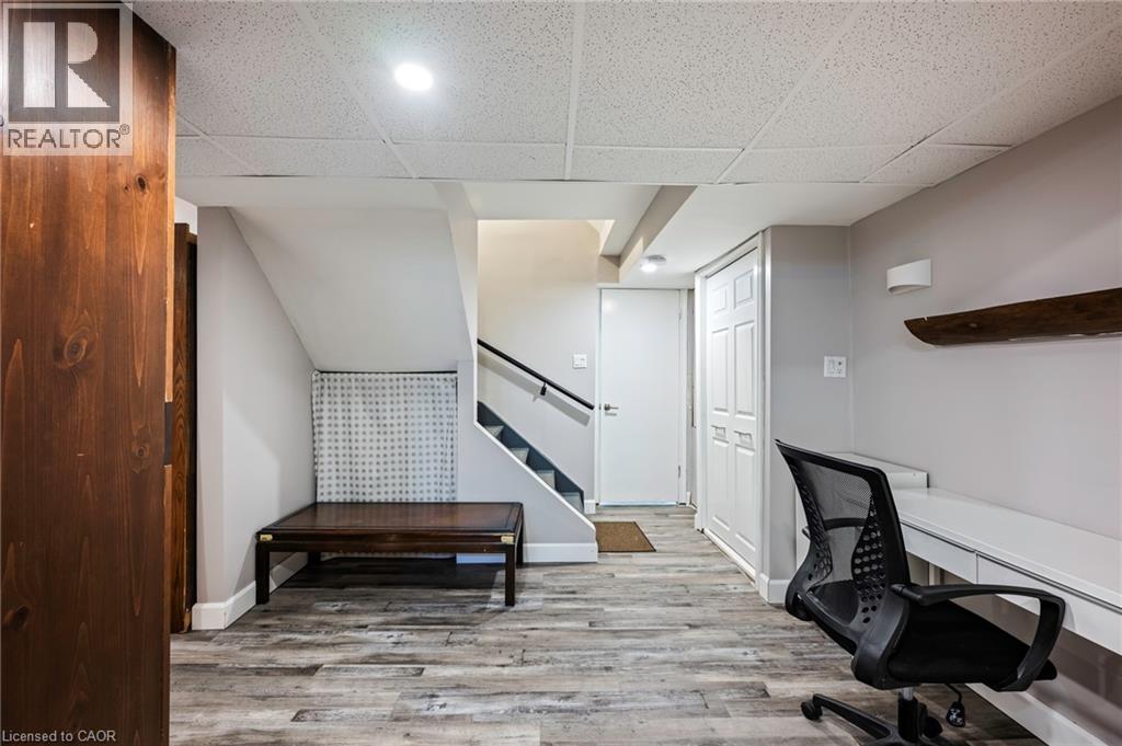 Wood-finish flooring, drop ceiling, built-in desk, built-in storage, and recessed lighting - 364 Stoneheight Place, Waterloo, ON