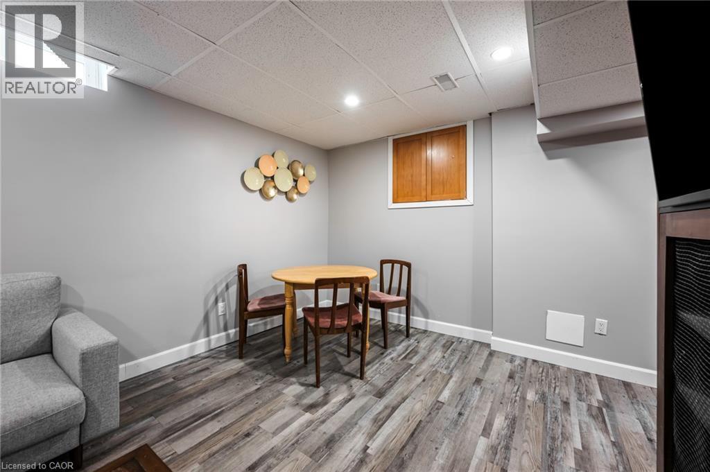 Wood-finish flooring with white baseboards and light gray walls - 364 Stoneheight Place, Waterloo, ON