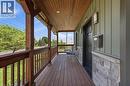 Inviting front porch featuring rich wood-finish flooring and ceiling - 69 Nash Road S, Hamilton, ON 