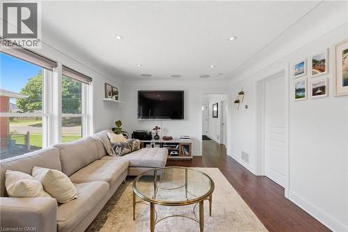 Bright living area featuring wood-finish flooring and recessed lighting - 69 Nash Road S, Hamilton, ON 