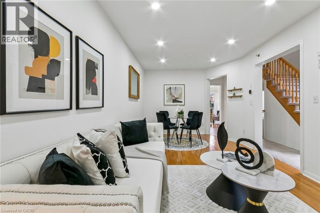 Recessed lighting illuminates the white walls and wood-finish flooring - 1373 Quest Circle, Mississauga, ON