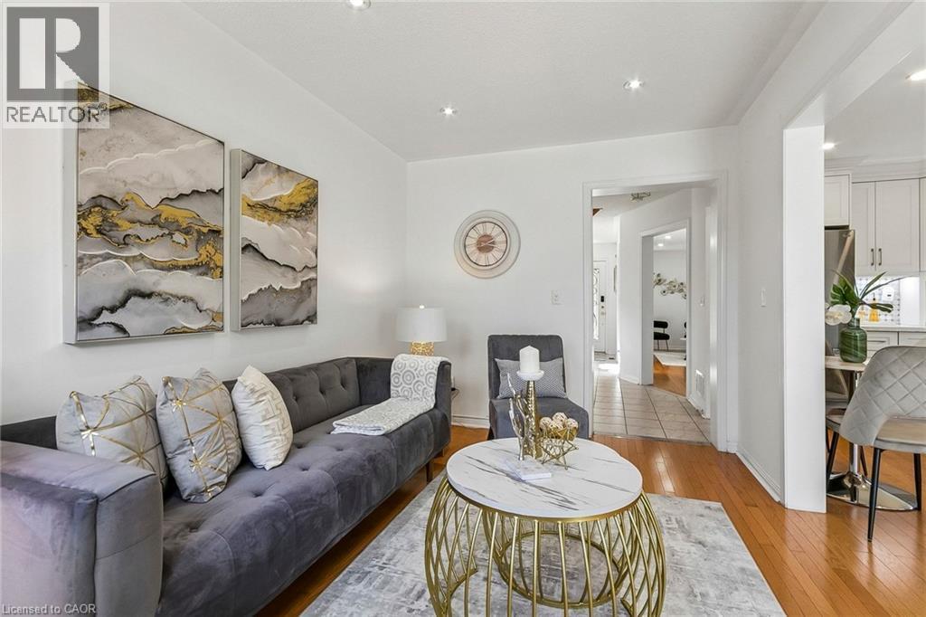 Hardwood-style flooring throughout, recessed lighting, and a brightly painted interior - 1373 Quest Circle, Mississauga, ON