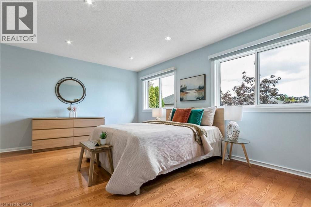 Recessed lighting, wood-finish flooring, and multiple windows with white trim - 1373 Quest Circle, Mississauga, ON