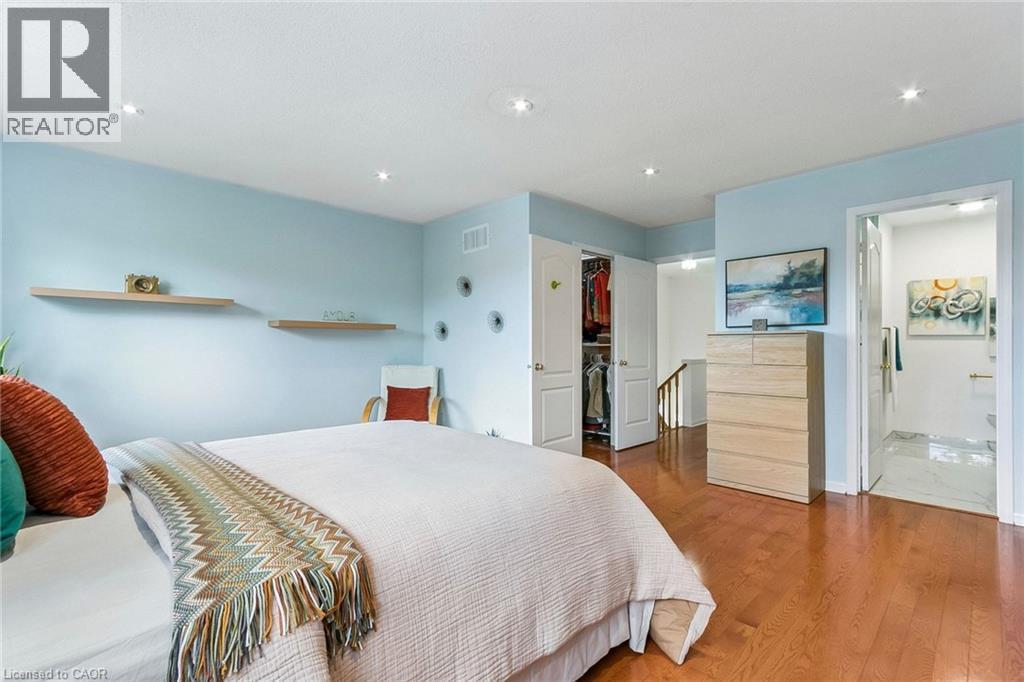 Recessed lighting, wood-finish flooring, light blue wall finishes, floating shelves, and a built-in closet - 1373 Quest Circle, Mississauga, ON