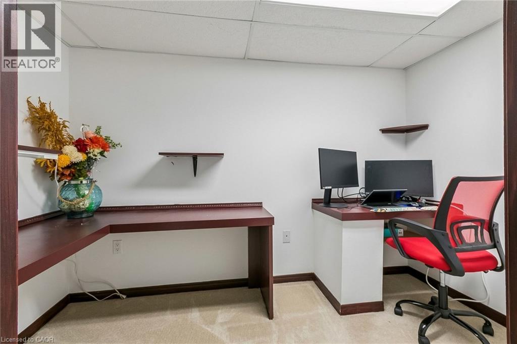 Built-in corner desk, wall-mounted shelving, and carpet flooring - 1373 Quest Circle, Mississauga, ON