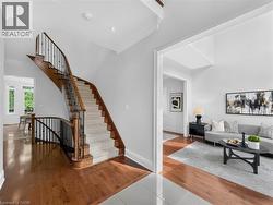 Grand curved staircase with wood treads and wrought iron spindles -