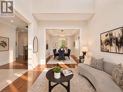 Hardwood flooring, recessed lighting, crown molding, cased openings, and a tray ceiling -