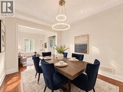 Recessed lighting, crown molding, wood-finish flooring, and a contemporary chandelier -