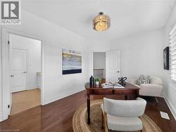 Wood-finish flooring, white window shutters, and a contemporary chandelier -