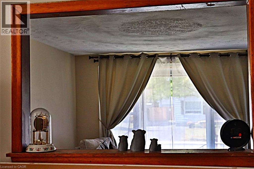 View from kitchen into the living room - 348 Weir Street N, Hamilton, ON