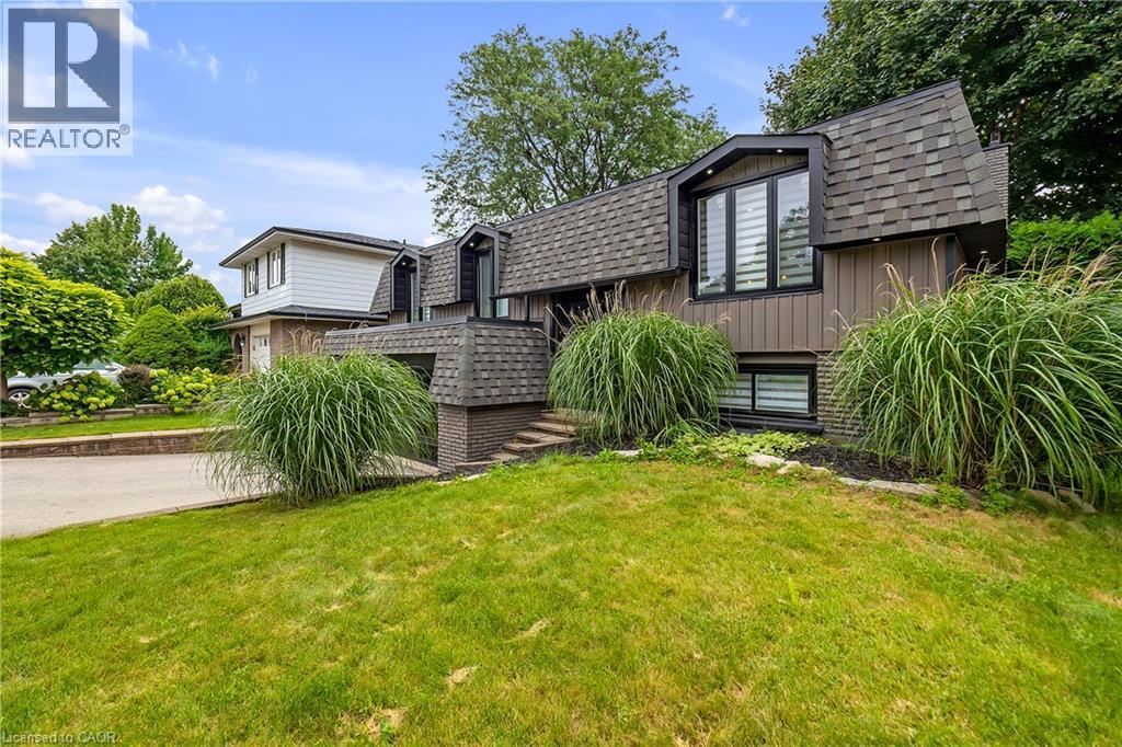 Split-level exterior with dark shingles and brown siding - 4236 Longmoor Drive, Burlington, ON