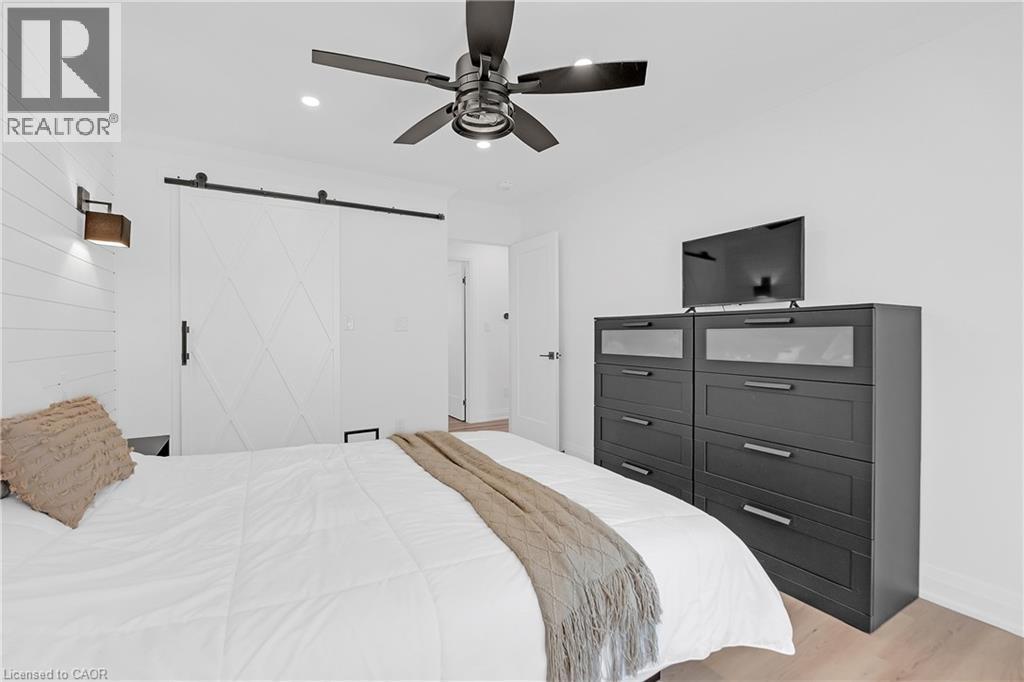 Recessed lighting, wood-finish flooring, and a contemporary ceiling fan with integrated lighting - 4236 Longmoor Drive, Burlington, ON