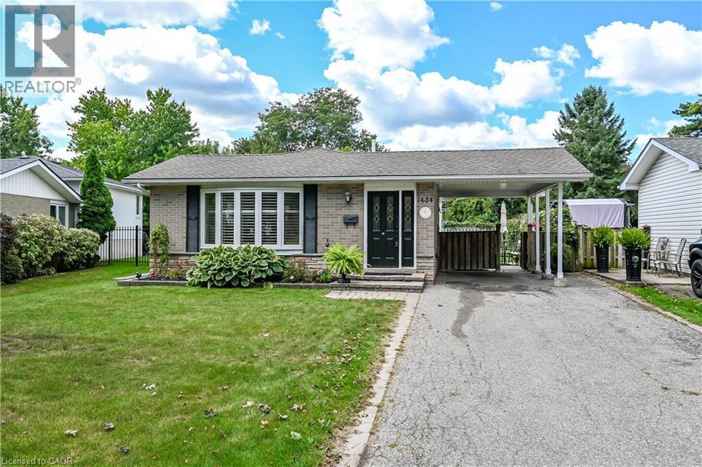 Brick exterior with a prominent bay window, attached carport, and a paved driveway - 1434 Dewbourne Crescent, Burlington, ON