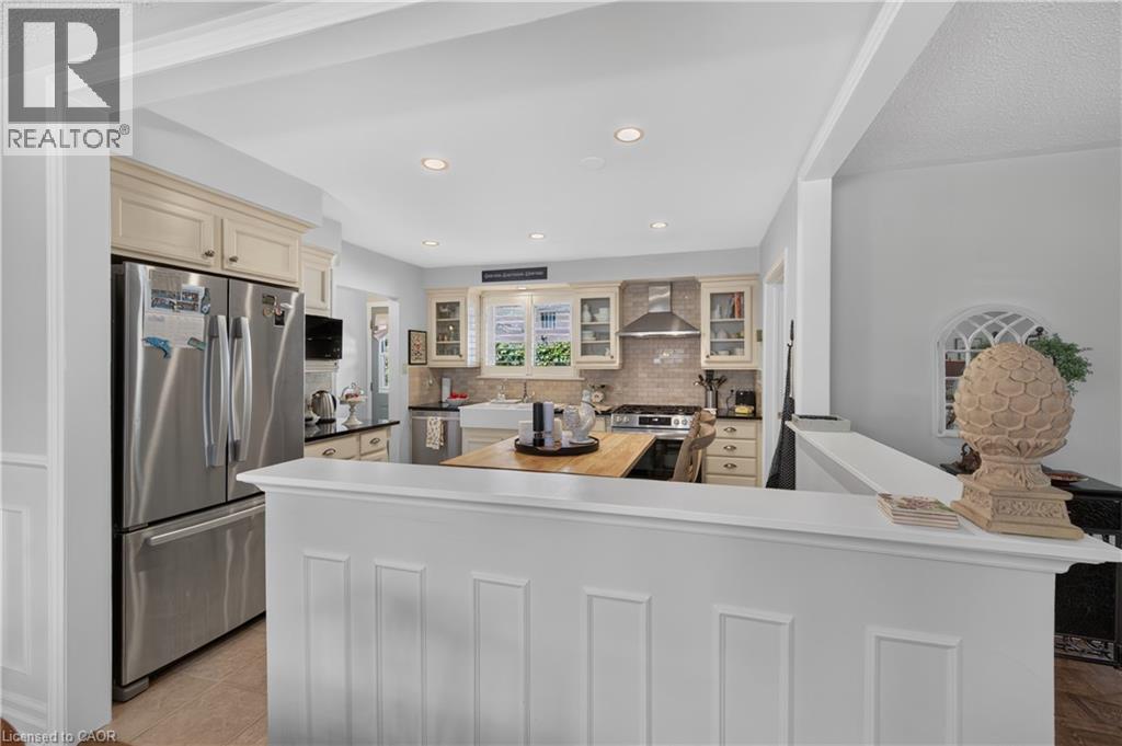 Kitchen with recessed lighting, stainless steel appliances, light-toned cabinetry, and a butcher block countertop - 1434 Dewbourne Crescent, Burlington, ON