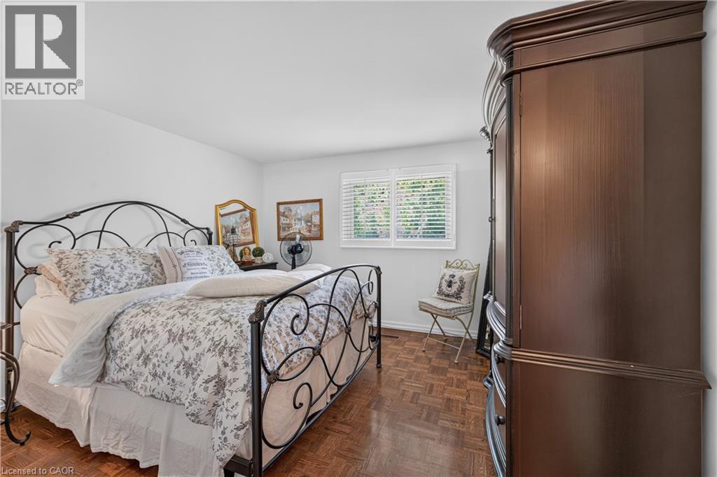 Wood-finish parquet flooring, white walls, and a window with white blinds - 1434 Dewbourne Crescent, Burlington, ON
