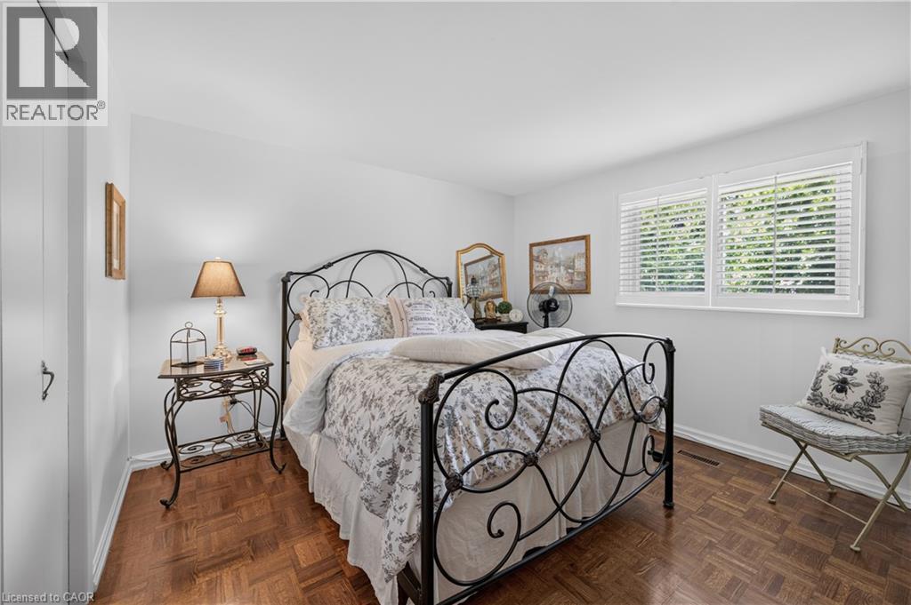 Wood-finish parquet flooring, white walls, and a window with white louvered blinds - 1434 Dewbourne Crescent, Burlington, ON