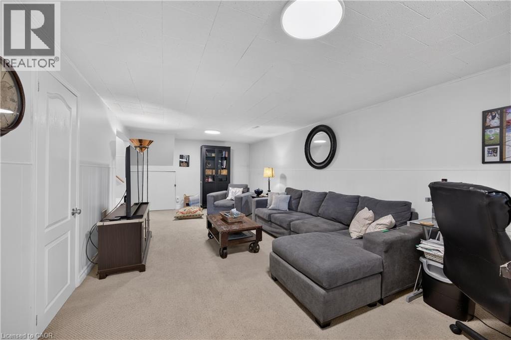 Recessed lighting, wall paneling, and neutral carpet flooring - 1434 Dewbourne Crescent, Burlington, ON