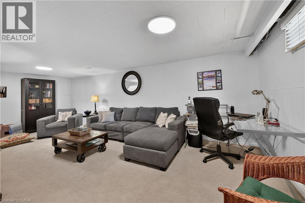 Wall-to-wall carpeting, recessed lighting, and a window with blinds provide illumination - 1434 Dewbourne Crescent, Burlington, ON