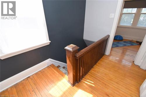 Hardwood flooring, painted walls, white trim, and a wood railing - 35 Tisdale Street S, Hamilton, ON 