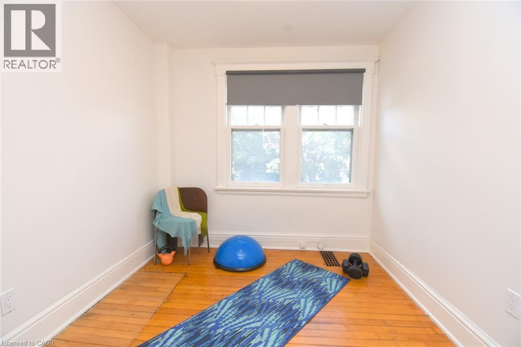 Hardwood flooring, white painted walls, double-hung window, window casing, baseboards - 35 Tisdale Street S, Hamilton, ON