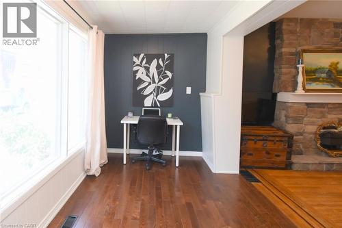 Hardwood flooring throughout, stone fireplace surround, and expansive window - 35 Tisdale Street S, Hamilton, ON 