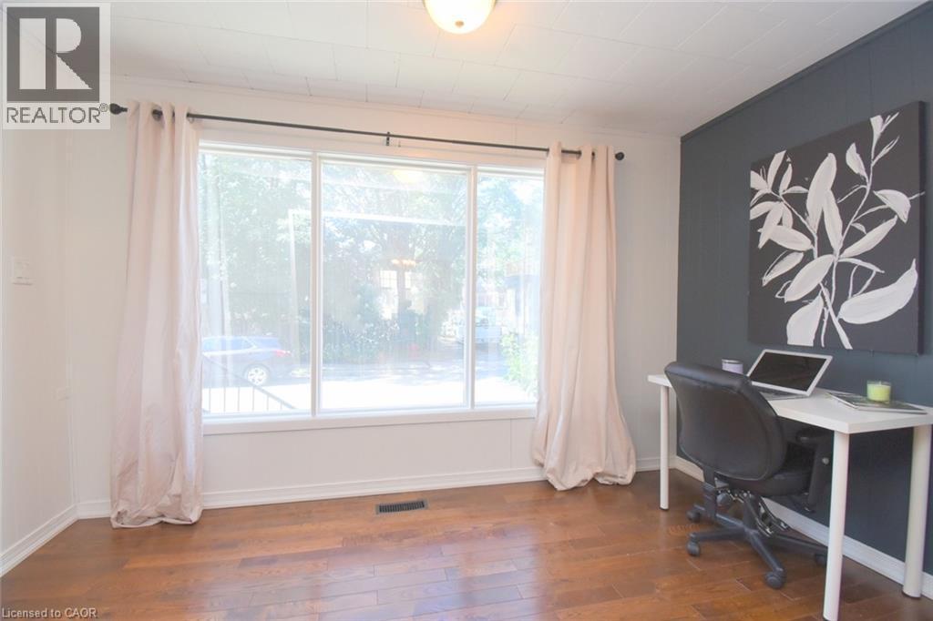 Hardwood flooring, recessed lighting, and a large picture window with white trim - 35 Tisdale Street S, Hamilton, ON