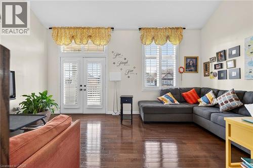 Living room featuring dark wood-style floors, french doors, and lofted ceiling - 97 Sirente Drive, Hamilton, ON 