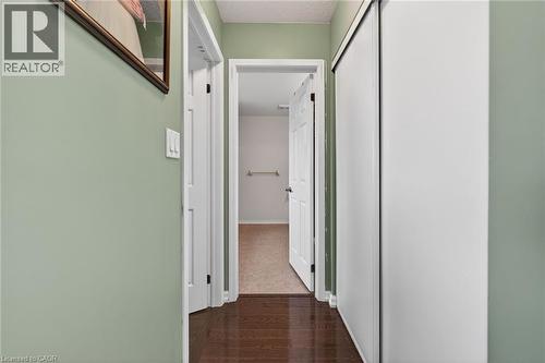 Corridor featuring dark wood-style floors and a textured ceiling - 97 Sirente Drive, Hamilton, ON 