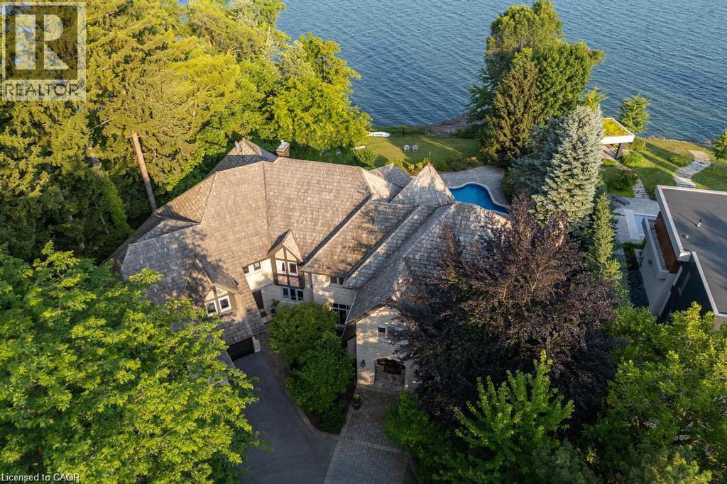 Stone and stucco exterior with exposed timber framing - 4038 Lakeshore Road, Burlington, ON
