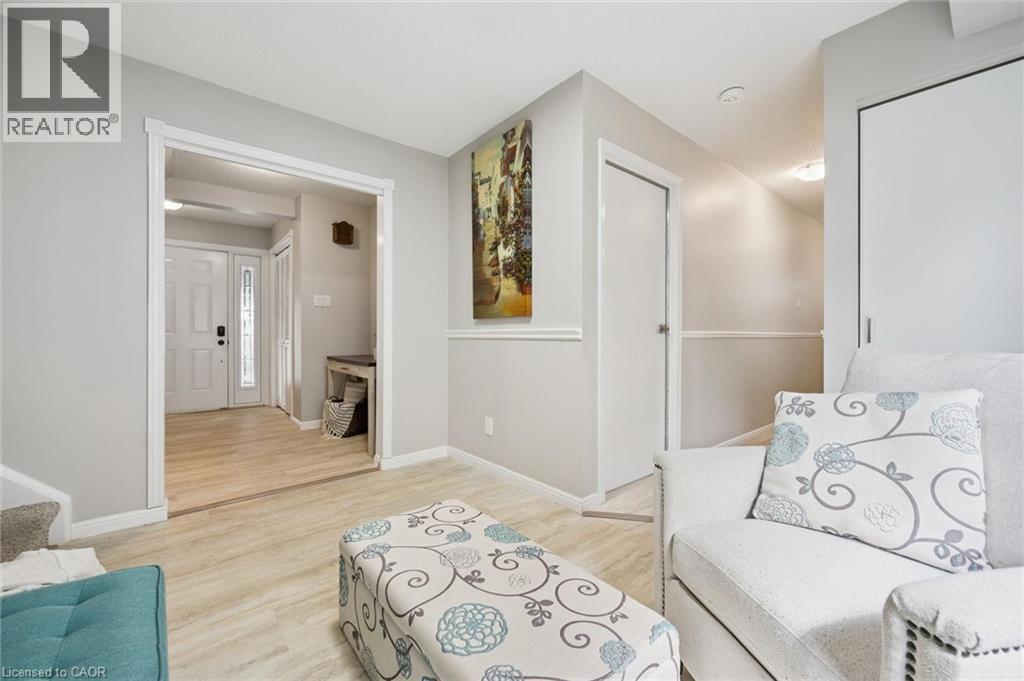 Light-colored wood-finish flooring, white trim details, and neutral wall tones - 21 Colebrook Court, Kitchener, ON