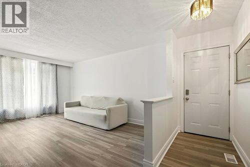Wood-finish flooring, white walls, and a paneled entry door - 27 Gretna Court, Hamilton, ON 